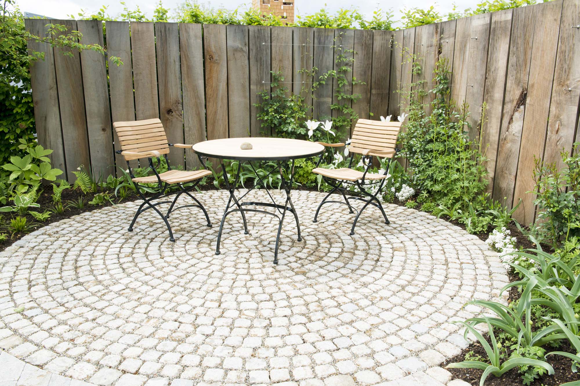 Paved patio area with metal table & chairs